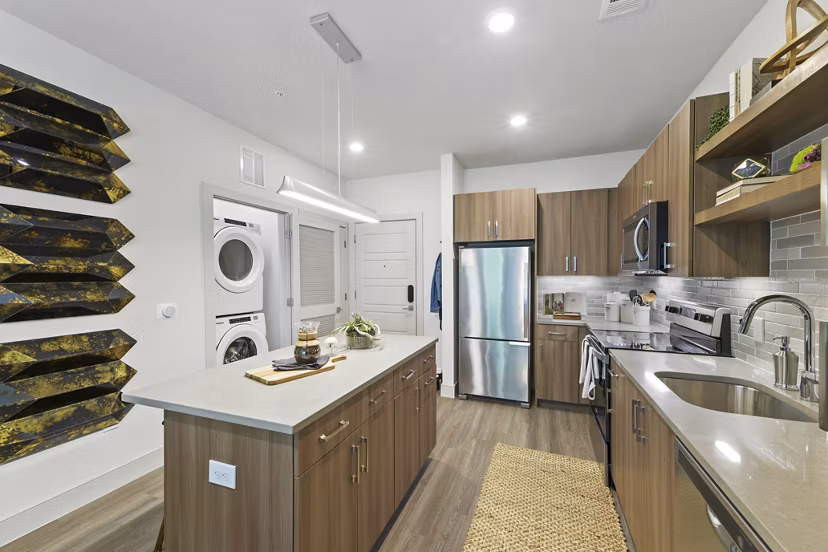 Modern kitchen with stainless steel appliances at The Ian Apartments
