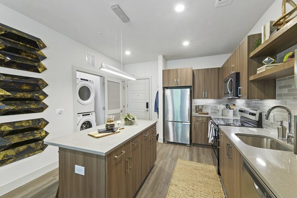 Modern kitchen with stainless steel appliances at The Ian Apartments