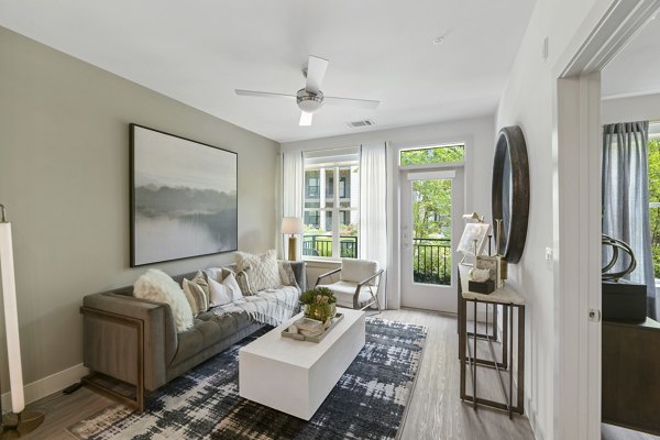 Spacious living room with modern dÃ©cor in The Ian Apartments, luxury high-rise by Greystar