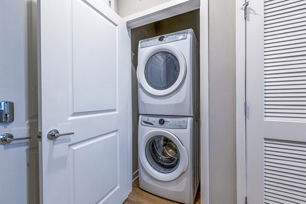 laundry room at Alexan Mill District Apartments