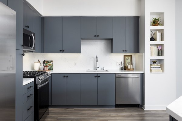 Modern kitchen with stainless steel appliances and sleek countertops at Broadstone Edition Apartments
