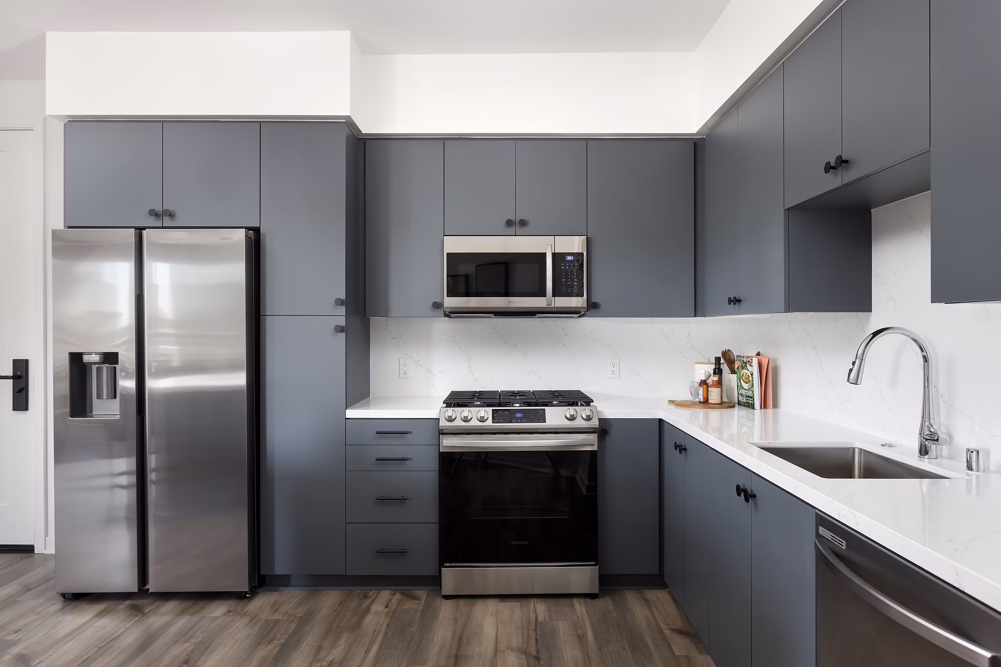 Modern kitchen with stainless steel appliances in Broadstone Edition Apartments
