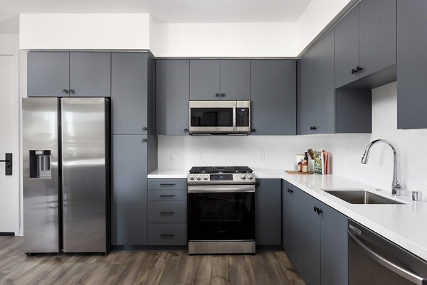 Modern kitchen with stainless steel appliances in Broadstone Edition Apartments