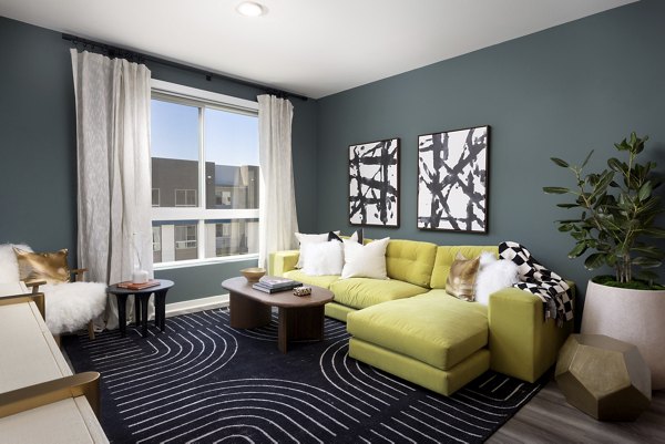 Modern living room with chic decor and large windows at Broadstone Edition Apartments