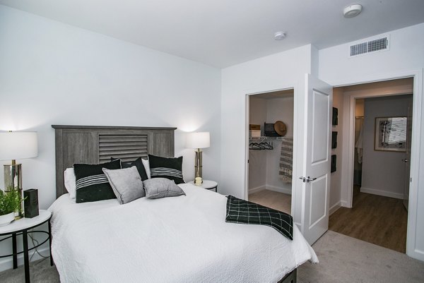 Spacious bedroom featuring modern decor at The Apex @ Meadows Apartments