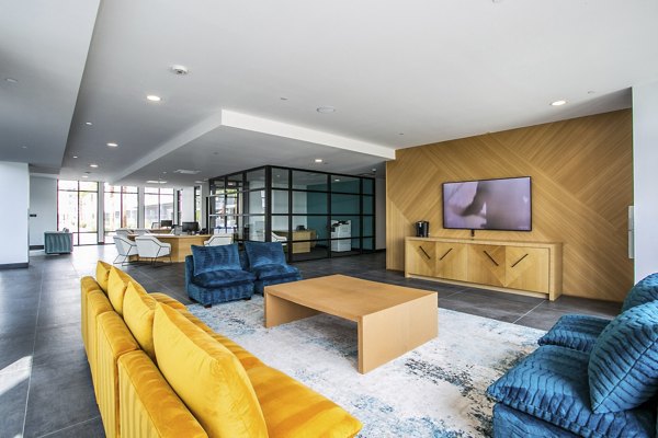 Clubhouse at The Apex @ Meadows Apartments with modern design and spacious seating, perfect for community events and gatherings