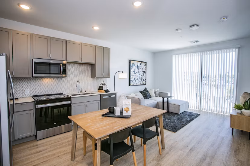 Modern kitchen with sleek countertops and stainless steel appliances at theApex @ Meadows Apartments Perfect for luxury living in comfort and style