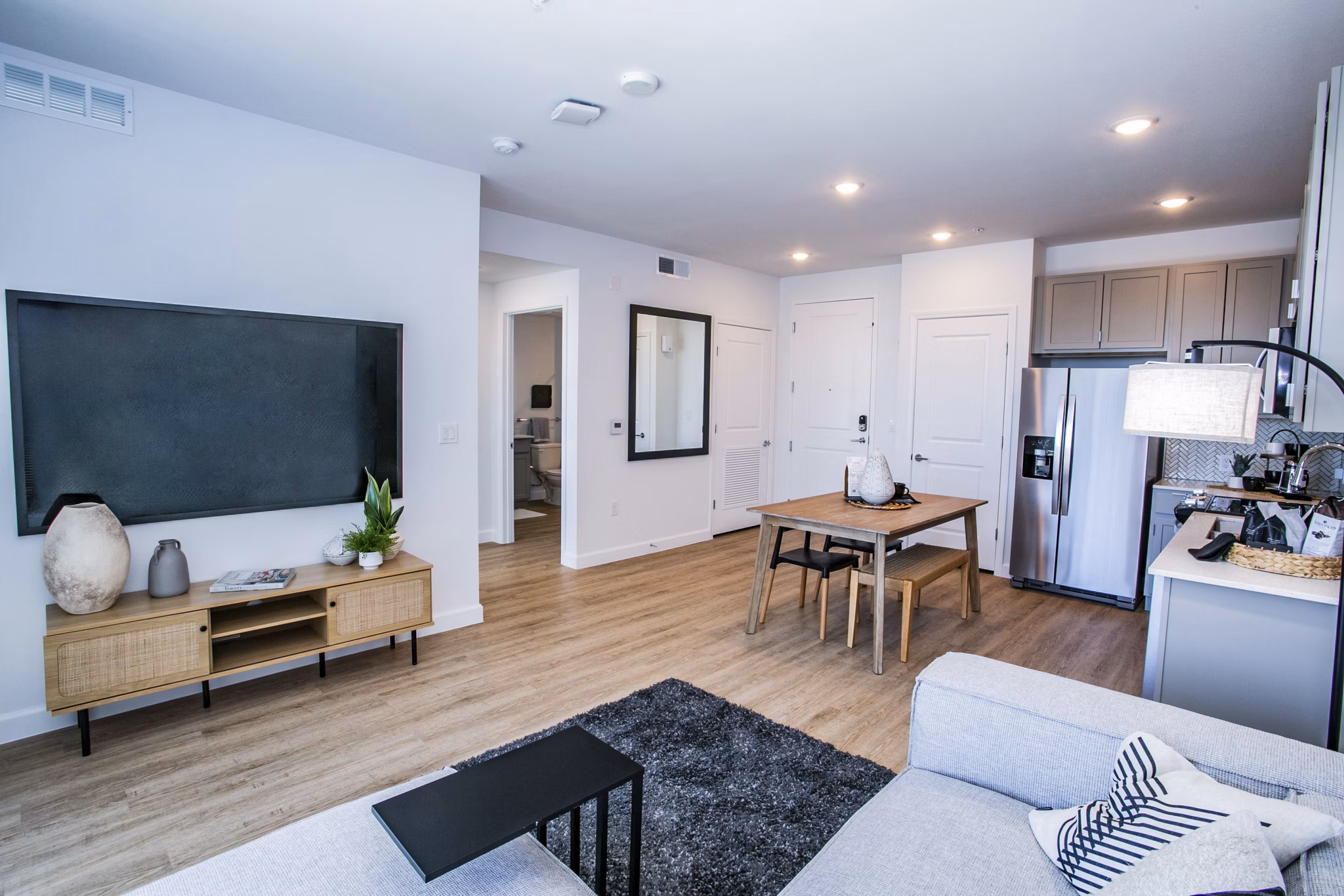 Spacious living room with modern decor at The Apex @ Meadows Apartments, featuring luxury design elements