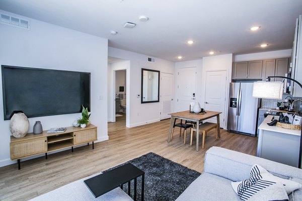 Spacious living room with modern decor at The Apex @ Meadows Apartments, featuring luxury design elements