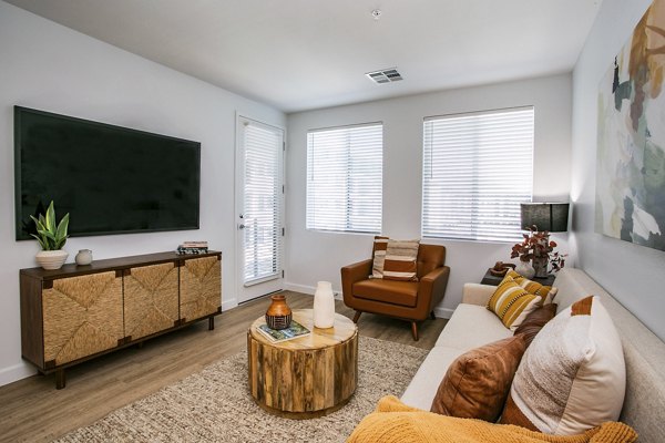Spacious living room with modern decor in theApex @ Meadows Apartments