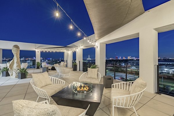 Fire pit with seating area at theApex @ Meadows Apartments, offering cozy outdoor relaxation space in serene surroundings