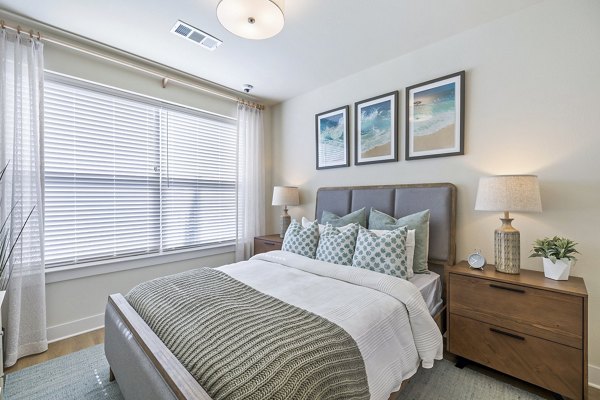 Spacious bedroom with modern decor and large windows at Birchway Spring Cypress Apartments