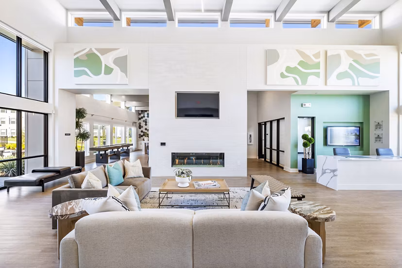 Clubhouse with modern design and cozy seating in Birchway Spring Cypress Apartments lobby
