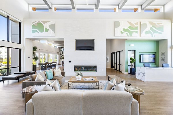 Clubhouse with modern design and cozy seating in Birchway Spring Cypress Apartments lobby