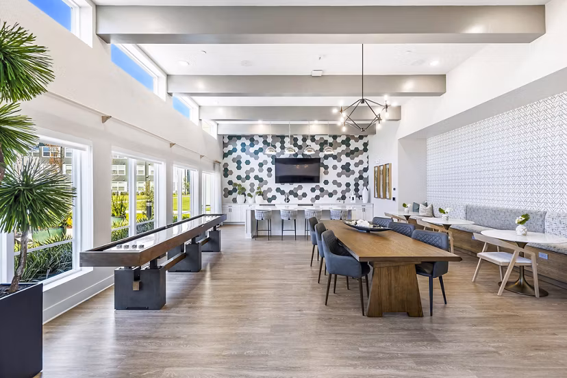 Clubhouse game room with pool table and lounge seating at Birchway Spring Cypress Apartments