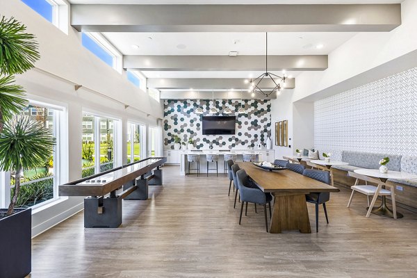 Clubhouse game room with pool table and lounge seating at Birchway Spring Cypress Apartments