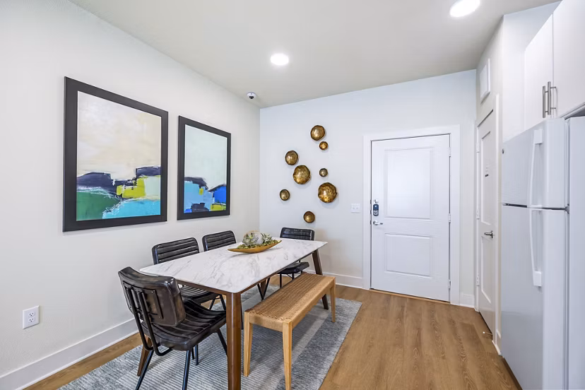 Dining room with contemporary decor and hardwood floors at Birchway Spring Cypress Apartments