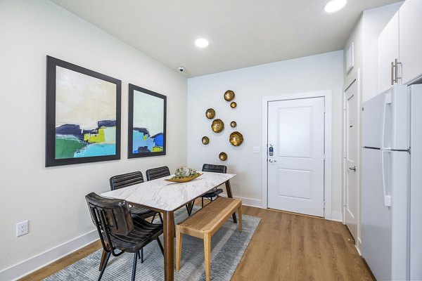 Dining room with contemporary decor and hardwood floors at Birchway Spring Cypress Apartments