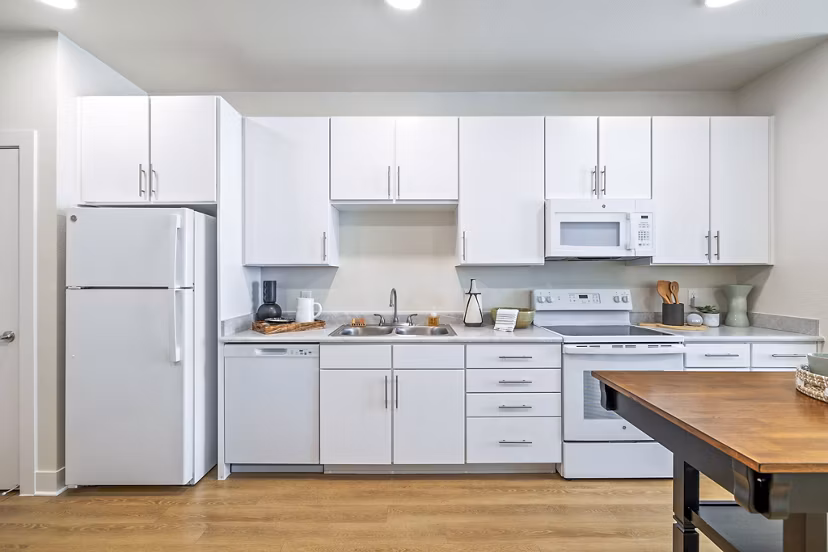 Modern kitchen with stainless steel appliances at Birchway Spring Cypress Apartments luxury community