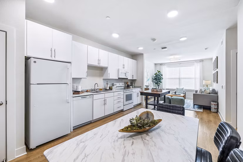 Dining room/kitchen with modern appliances and island in Birchway Spring Cypress Apartments