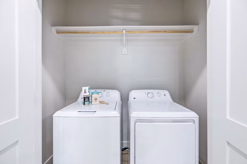 Laundry room featuring modern appliances at Birchway Spring Cypress Apartments