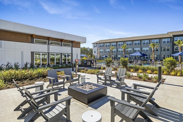 Fire pit patio at Birchway Spring Cypress Apartments with cozy seating and ambient lighting for outdoor relaxation