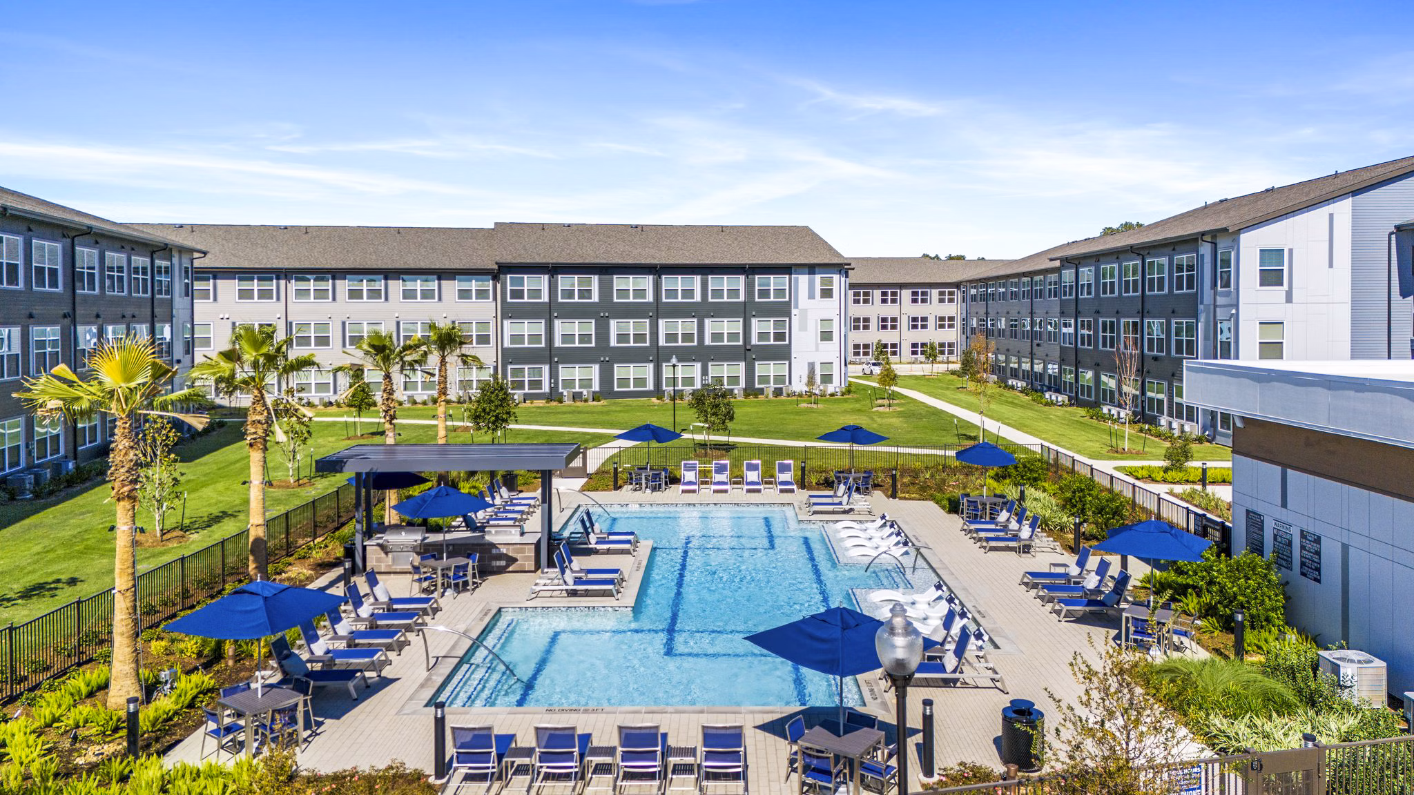 Resort-style pool with lush landscaping at Birchway Spring Cypress Apartments, perfect for relaxation and leisure activities