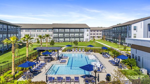 Resort-style pool with lush landscaping at Birchway Spring Cypress Apartments, perfect for relaxation and leisure activities