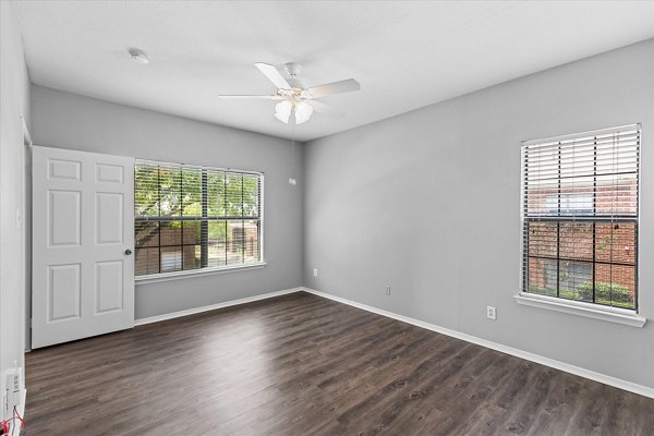 Cozy bedroom with neutral palette at Madison at Melrose Apartments