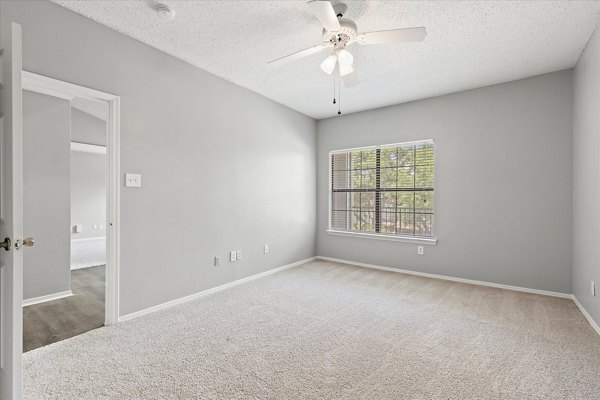 Elegant bedroom with plush bedding at Madison at Melrose Apartments