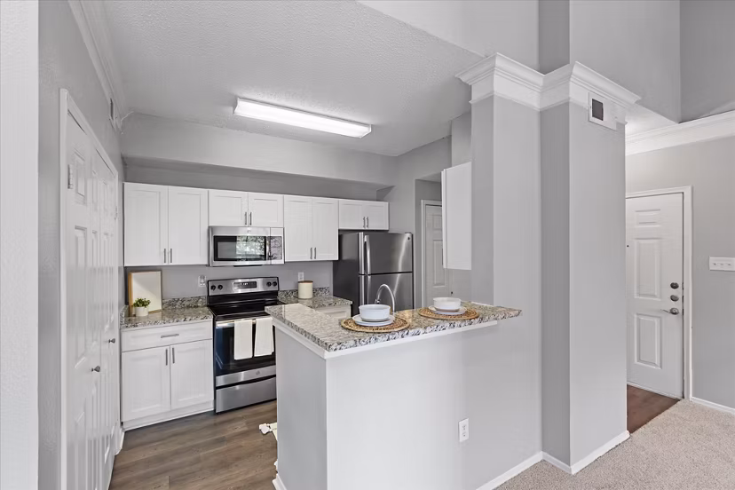 Modern kitchen with stainless steel appliances in Madison at Melrose Apartments, perfect for luxury living