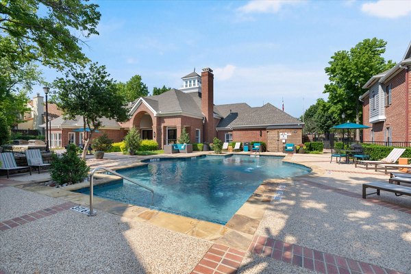 Poolside relaxation at Madison at Melrose Apartments featuring luxurious seating and sparkling pool