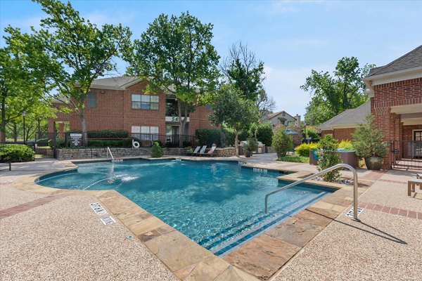 Sparkling pool with modern lounge chairs at Madison at Melrose Apartments, perfect for relaxation and leisure activities