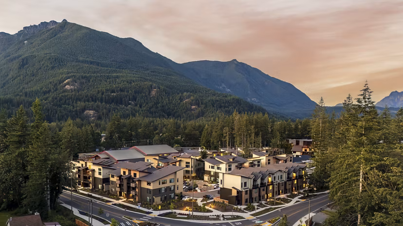 Luxury apartments nestled among trees and mountains in a serene environment