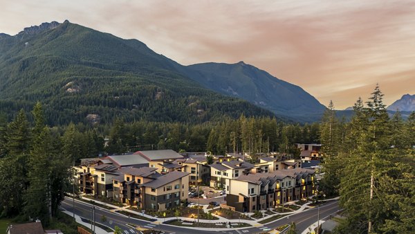 Luxury apartments nestled among trees and mountains in a serene environment