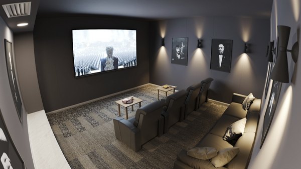 Traverse Apartments: Modern theater room with plush seating and large screen in luxury complex