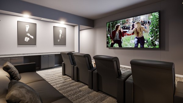Traverse Apartments: Modern theater room with comfortable seating and large screen at luxury apartments