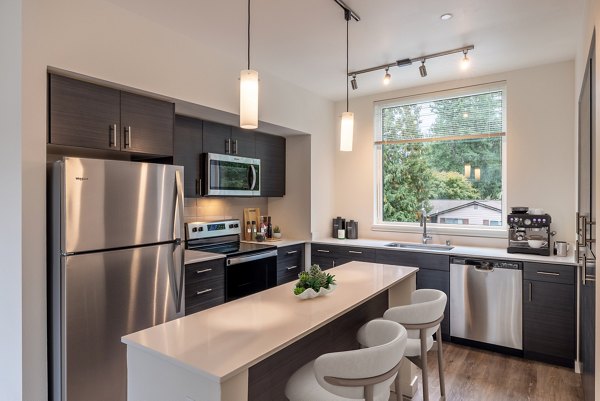 Kitchen with modern appliances and granite countertops at Traverse North Bend Apartments