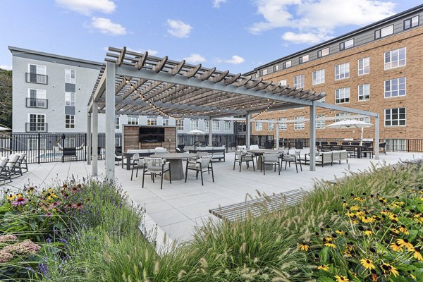 Courtyard with lush greenery and seating at Sanctuary at Winchester North Apartments, a luxury living community