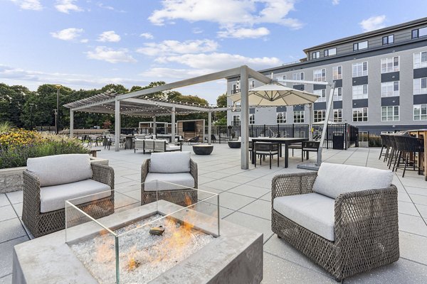 Fire pit area with cozy seating at Sanctuary at Winchester North Apartments, ideal for relaxation and outdoor gatherings