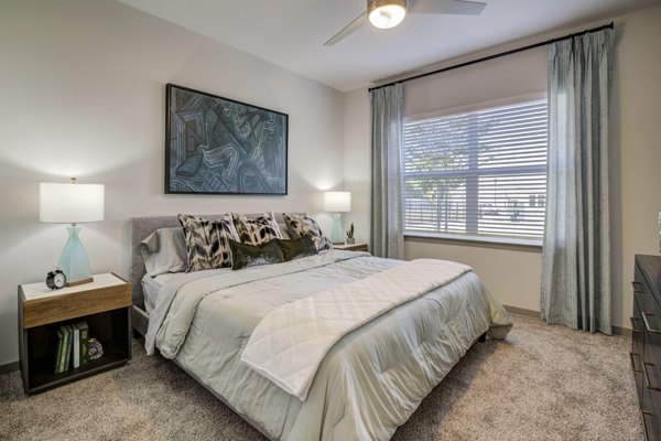 Bedroom featuring modern decor and cozy furnishings at Inscribe Apartments