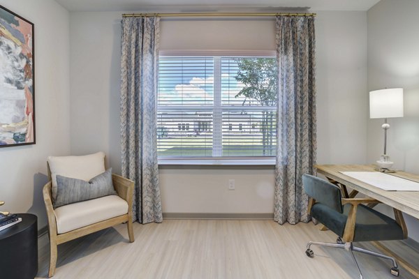 Modern home office with built-in desk and natural light at Inscribe Apartments