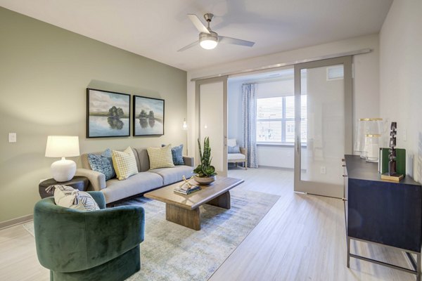 Contemporary living room with stylish decor and open floor plan at Inscribe Apartments