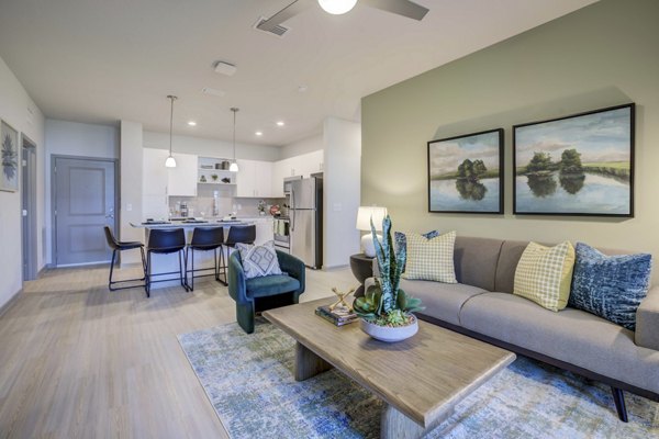 Living room with contemporary design and cozy seating area in Inscribe Apartments