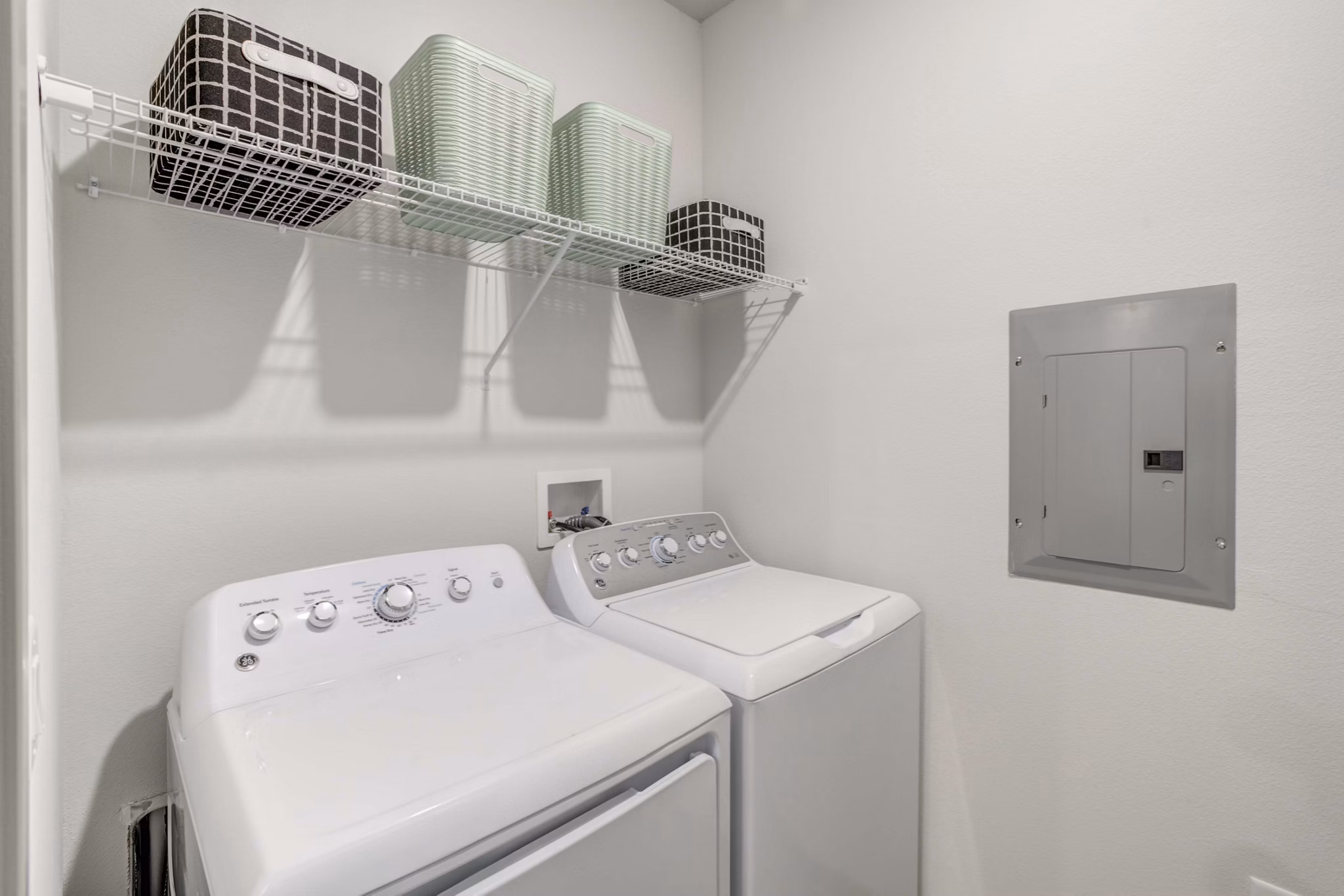 Laundry room with modern machines and folding area at Inscribe Apartments, Greystar luxury apartments in a convenient location