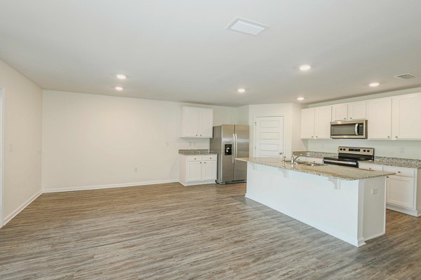 Cozy bedroom with modern furnishings at Sunset Village Apartments