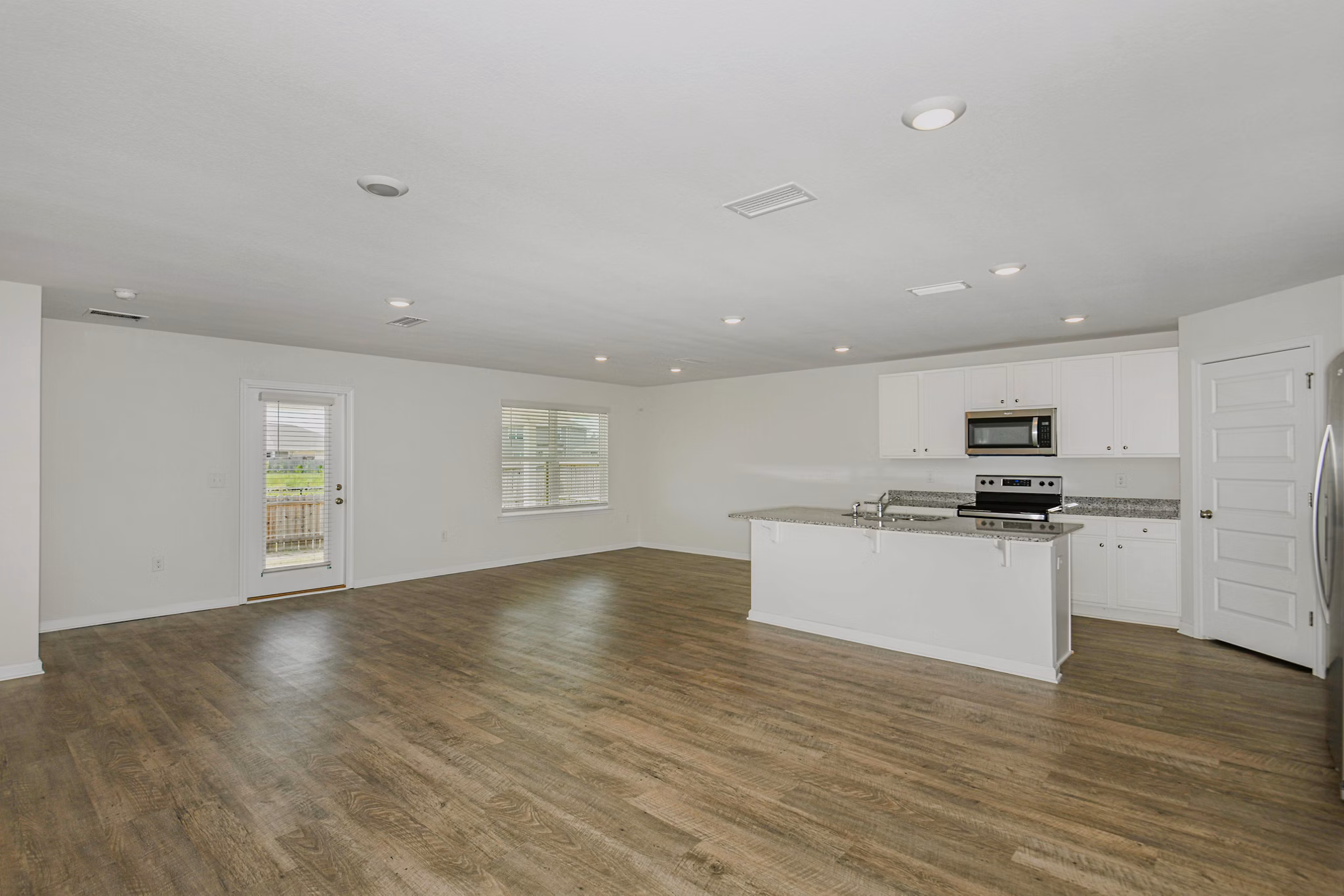 Elegant kitchen with marble countertops and stainless-steel appliances in Sunset Village Apartments