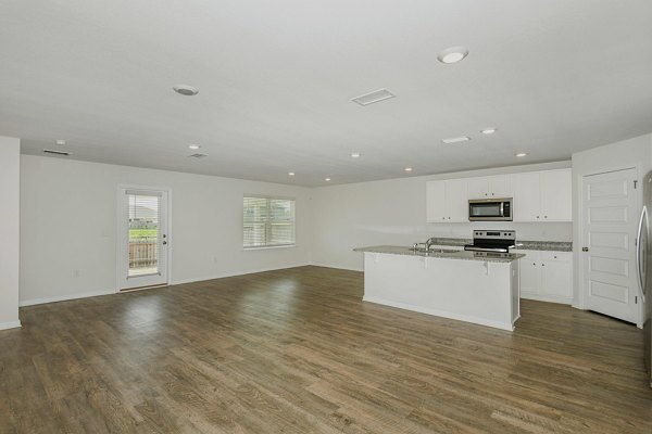 Elegant kitchen with marble countertops and stainless-steel appliances in Sunset Village Apartments