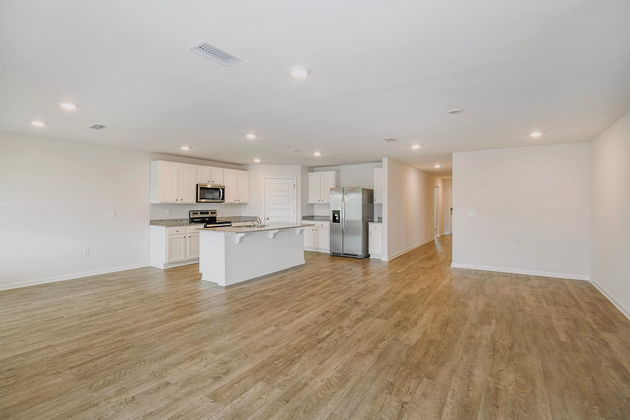 Spacious kitchen and dining area with sleek countertops in Sunset Village Apartments, offering luxury living