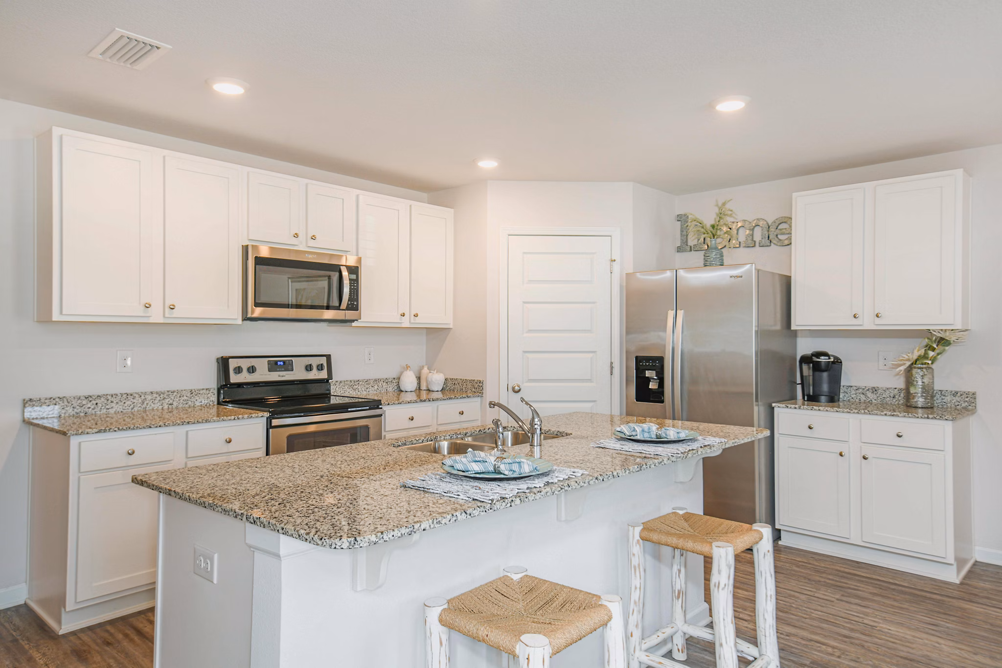 Kitchen featuring modern appliances and granite countertops at Sunset Village Apartments